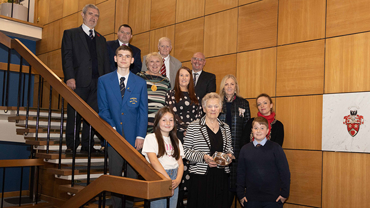 This image shows some of the winners of the Queen's Memorial awards with the council leader, Provost and chief exec