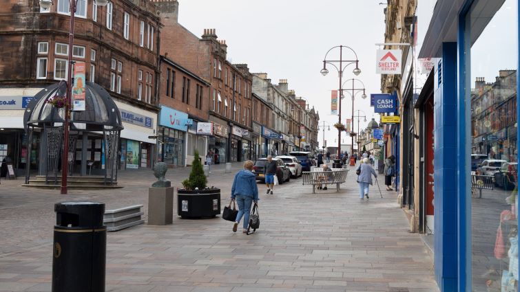 This an image of Quarry Street in Hamilton showing people walking in the street with shops and cars in the image