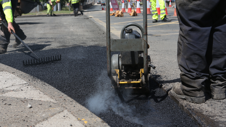 A close up of new tarmac being laid