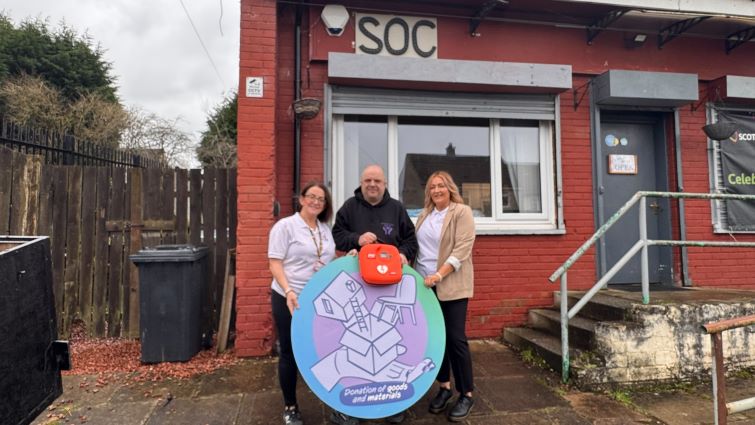 This image shows members of Supporting Our Community with a defibrillator they were given by Unite the Union through the council's Community Wish List