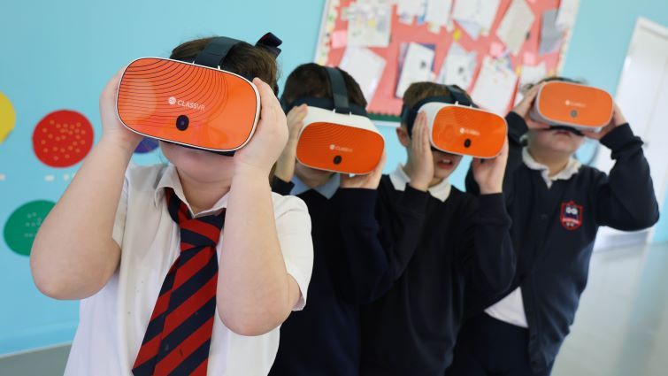 This image shows four of the pupils from the group wearing virtual reality headsets.
