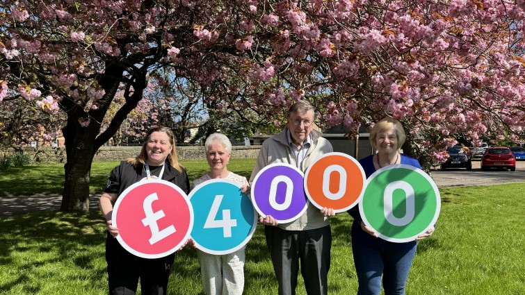 Members of Blantyre Livingstone Memorial Church Garden Group display the fact they have been awarded £4000 through Participatory Budgeting for a memorial garden.