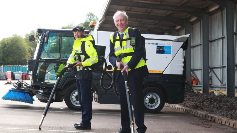 This image shows Councillor Robert Brown and a council employee with the machines used to remove chewing gum from roads and pavements