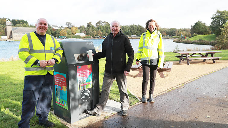 Cllr John Anderson is pictured with two council officers as they all put rubbish in the new solar bin on the side of the loch in James Hamilton Heritage Park. 