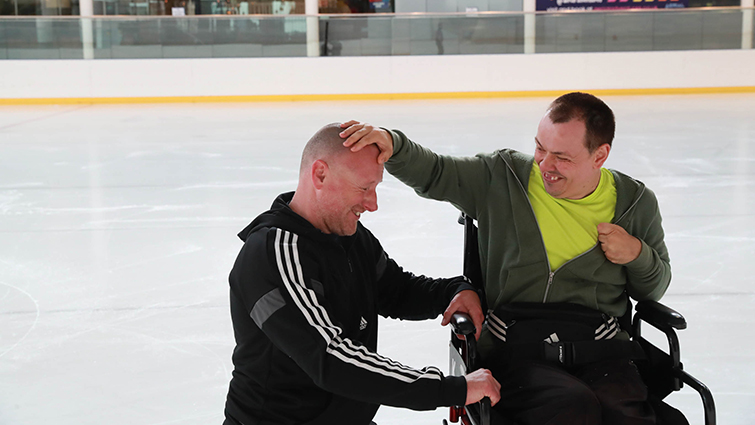This photo shows Steven and Graeme in close up on the ice, having a laugh together.