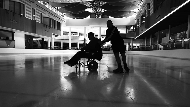 This is a photo showing Steven and Graeme in silhouette on the ice, and is in black and white.