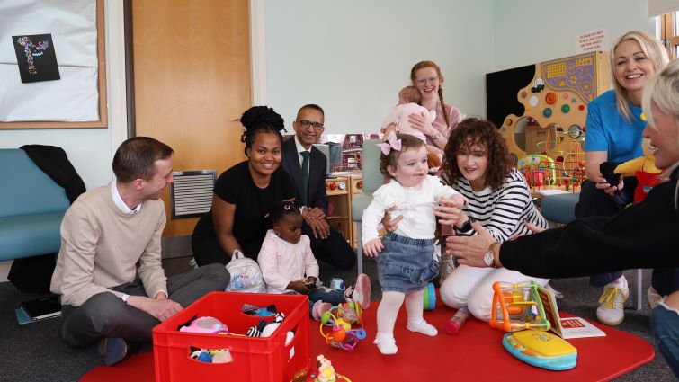 This image shows families. including children, during a visit to the Hamilton Family Support Hub by Fiona Duncan, Independent Strategic Advisor to The Promise