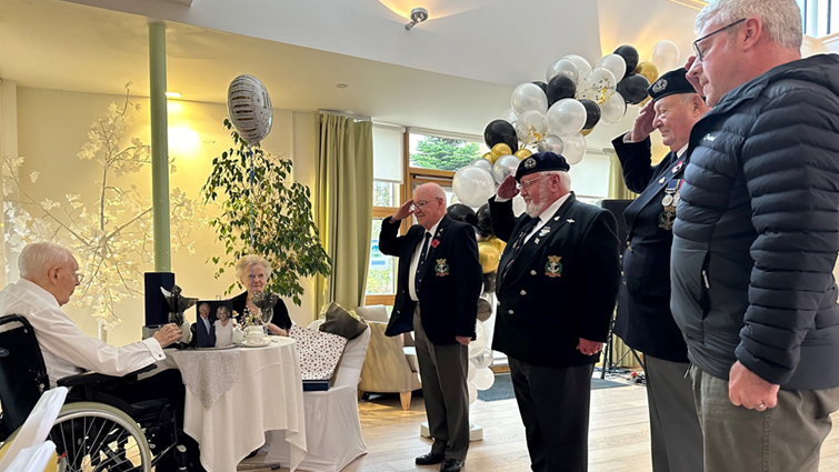 Navy veterans salute Gordon Cowan on his 100th birthday.