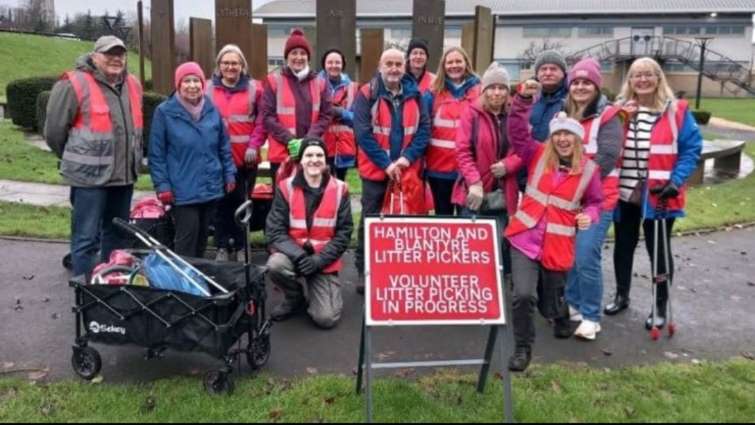 local litter picking group with road sign