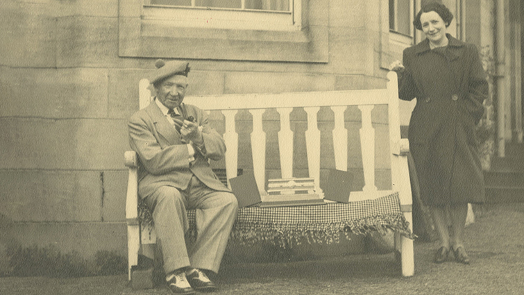 Sir Harry Lauder sitting outside Lauder Ha', his home in Strathaven, with his niece Greta