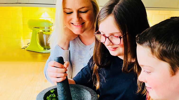 This image shows Laura cooking at home with her two children Niamh and Rory.