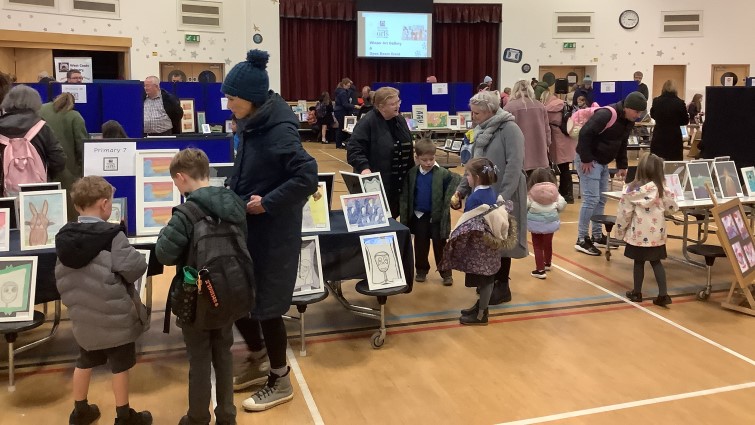 parents, pupils and teachers in gym hall