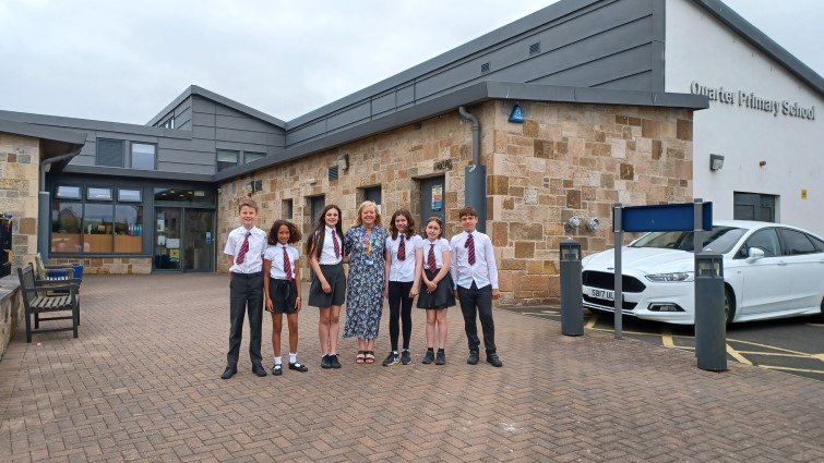 Quarter Primary School and Nursery Head Teacher Sharon Bokas with senior pupils outside the building