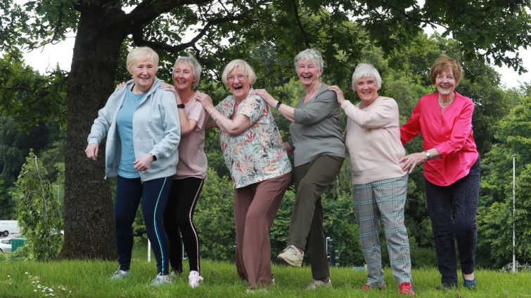 A group of six women delegates are pictured outside the venue taking part in the activity programme.