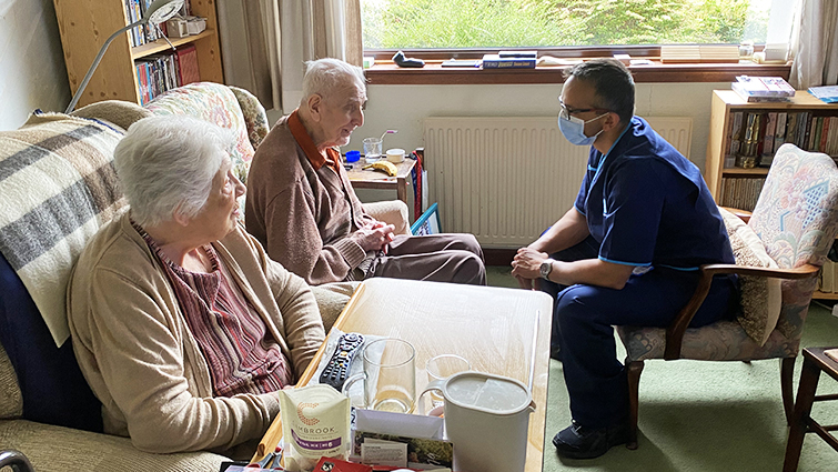 Soumen Sengupta chats with service-users Frances and John Errett.