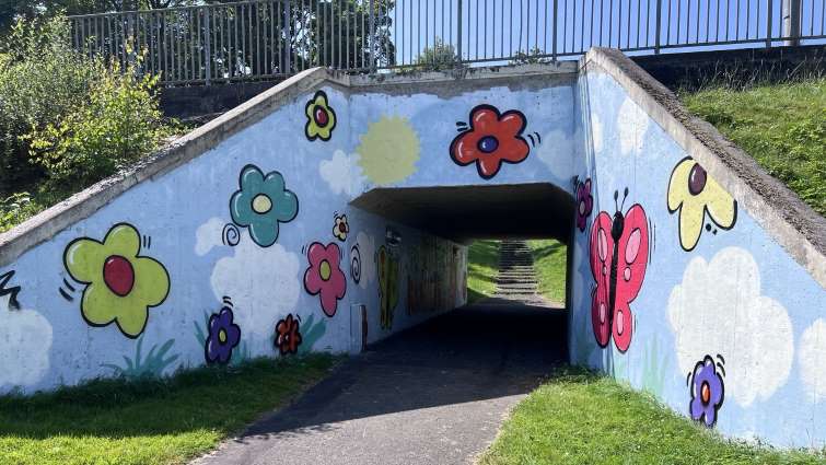 Universal Connection young people turning underpass entrance into a work of art