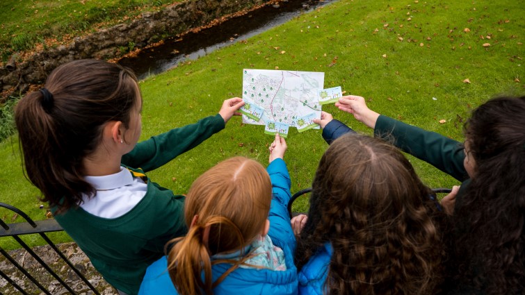 This is image shows young people looking at a map ahead of the launch of the Beat the Street game