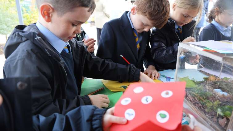pupils looking at sensory garden items