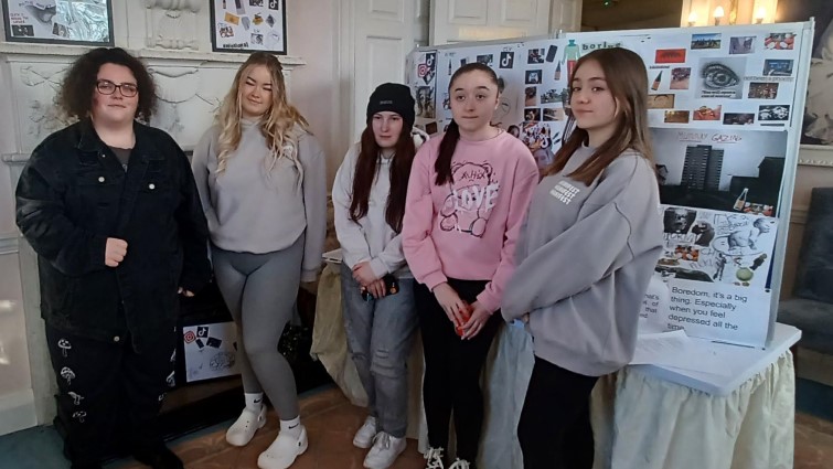 Young people who contributed to the Inclusion as Preventio art exhibition in front of their exhibits.