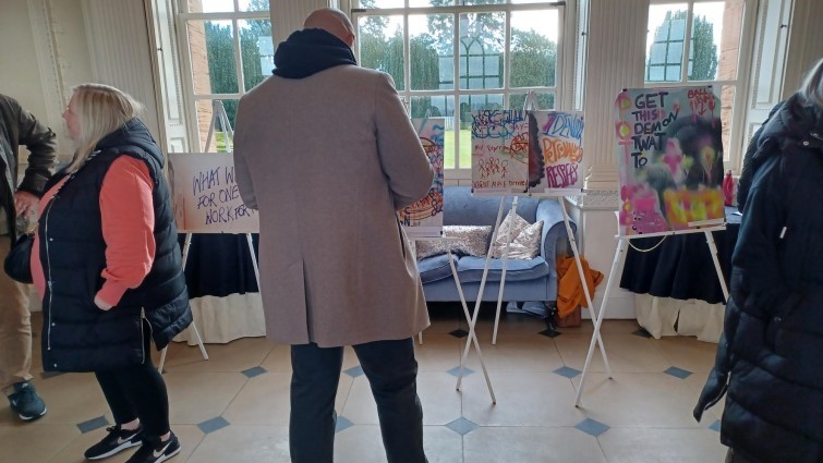 Guests admire the displays at the Inclusion as Prevention art exhibition